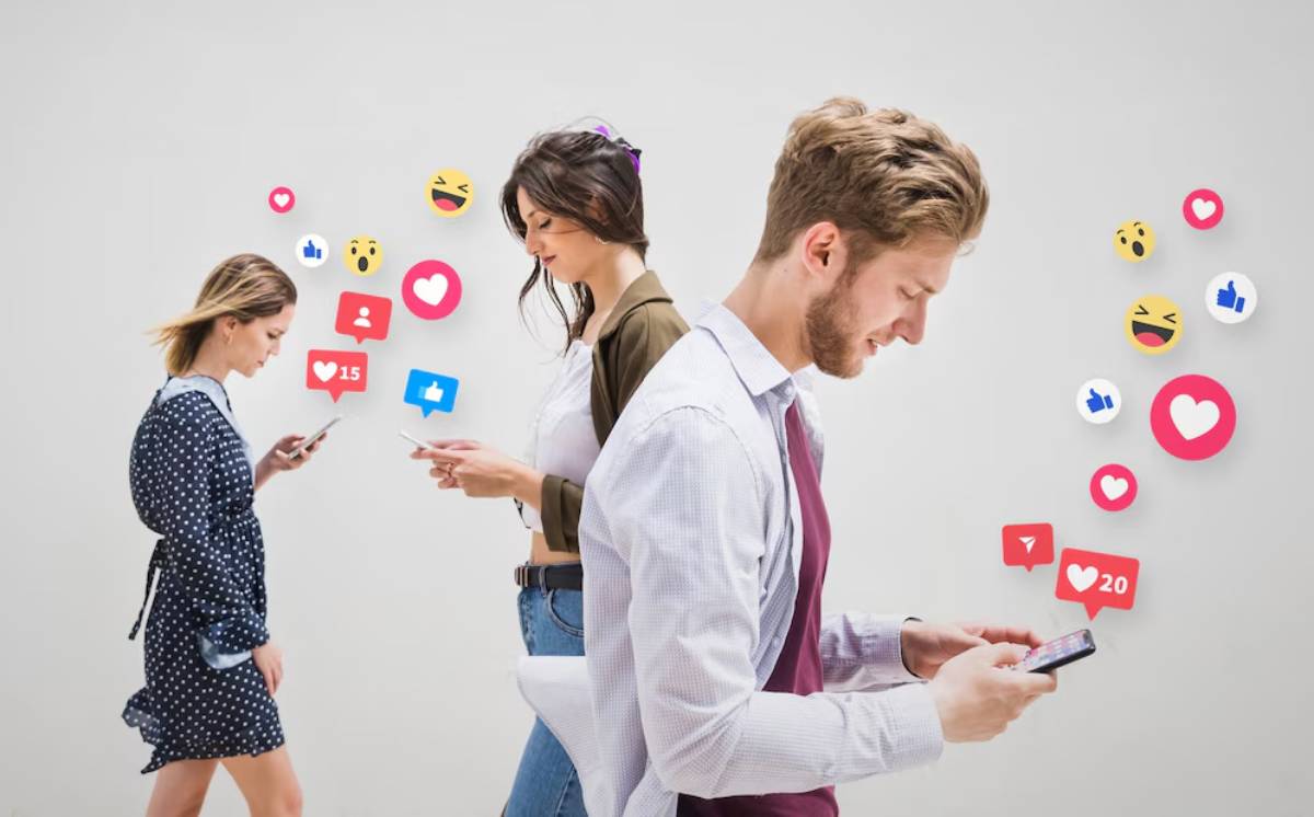 Three people using smartphones surrounded by floating social media icons and reactions.